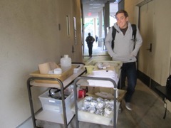 Mike, Teaching Fellow in-training, helps bring bacteria cloning demo materials.