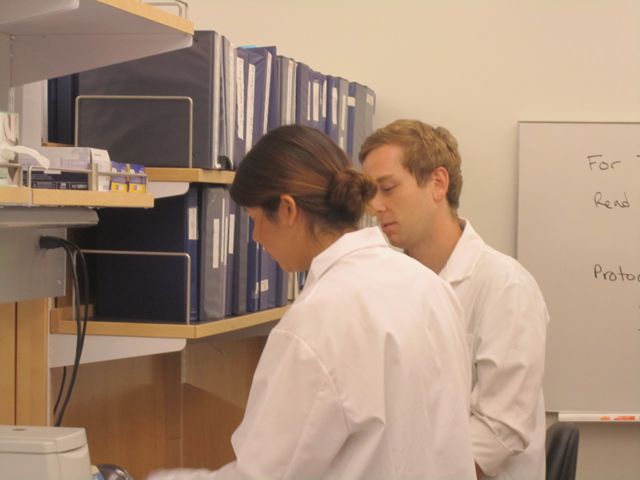 Lab assistant Mike Lyons discusses the lab protocol with Jazmin.