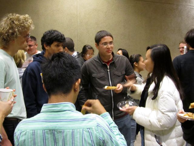 Nicholas continues discussion with Dr. Lee during reception.