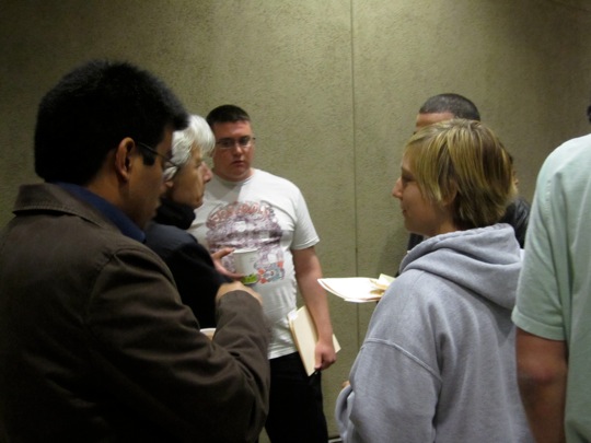 Krista looks on as Dr. Goldberg continues with discussion during reception.