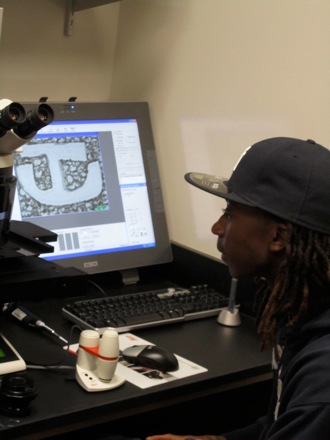 Oyejare practices his digital imaging techniques and draws the Tuskegee logo.