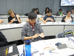 Students secure their bacteria cloning plates with tape.