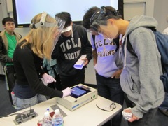 Graduate Kelli demonstrates the bands on a gel.