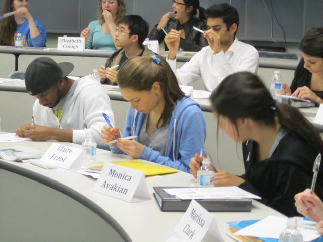 Students write their names on their DNA kit.