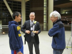 Harrison, Officer Klann's son converses with Professor Goldberg.