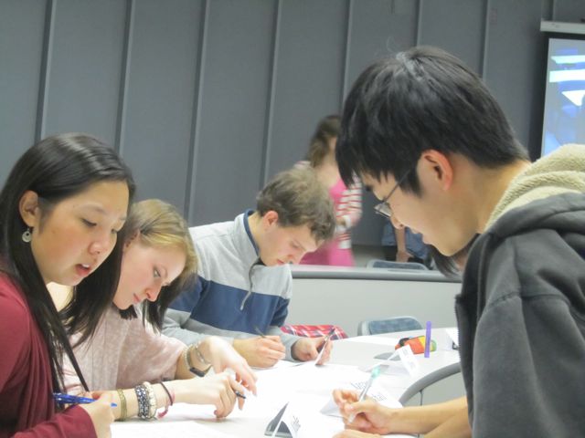 Ma, Narcis, Kyle, and Westley jot down their notes.