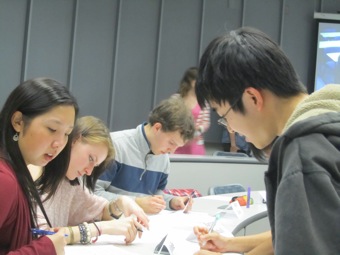 Ma, Narcis, Kyle, and Westley jot down their notes.