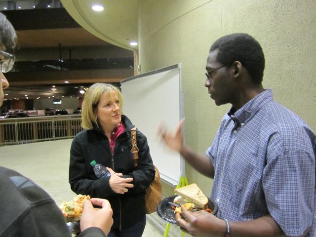 Dr. Evans extends lecture discussions during reception.