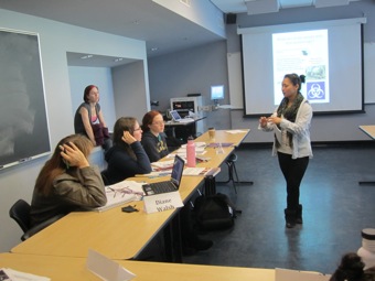 Elaine circulates in class and engages students to participate in discussion.