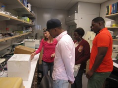 Kelli shows them some of the supplies used in the lab