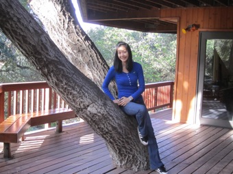 Jenn sitting on the tree.